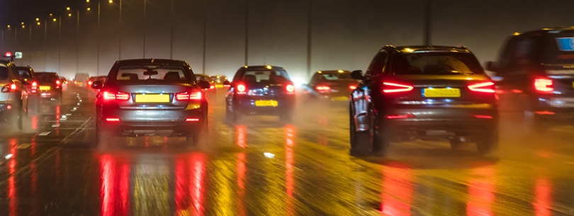 Motion Blur British Motorway Traffic and Police Panorama Panoramic web banner motion blurred photograph of traffic at in night in the rain on a British motorway with police officer and car